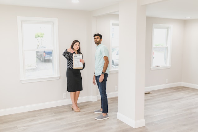 real estate agent showing empty home to tenant